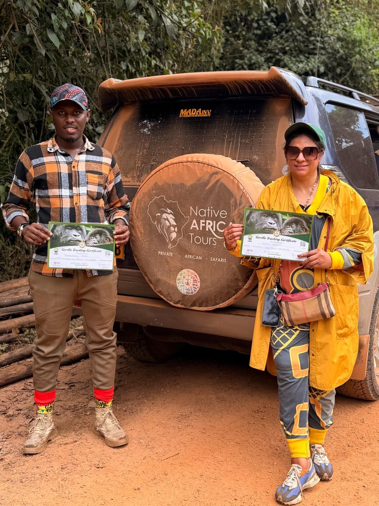 Traveller holding a gorilla trekking certificate with a Native Africa Tours guide in Uganda